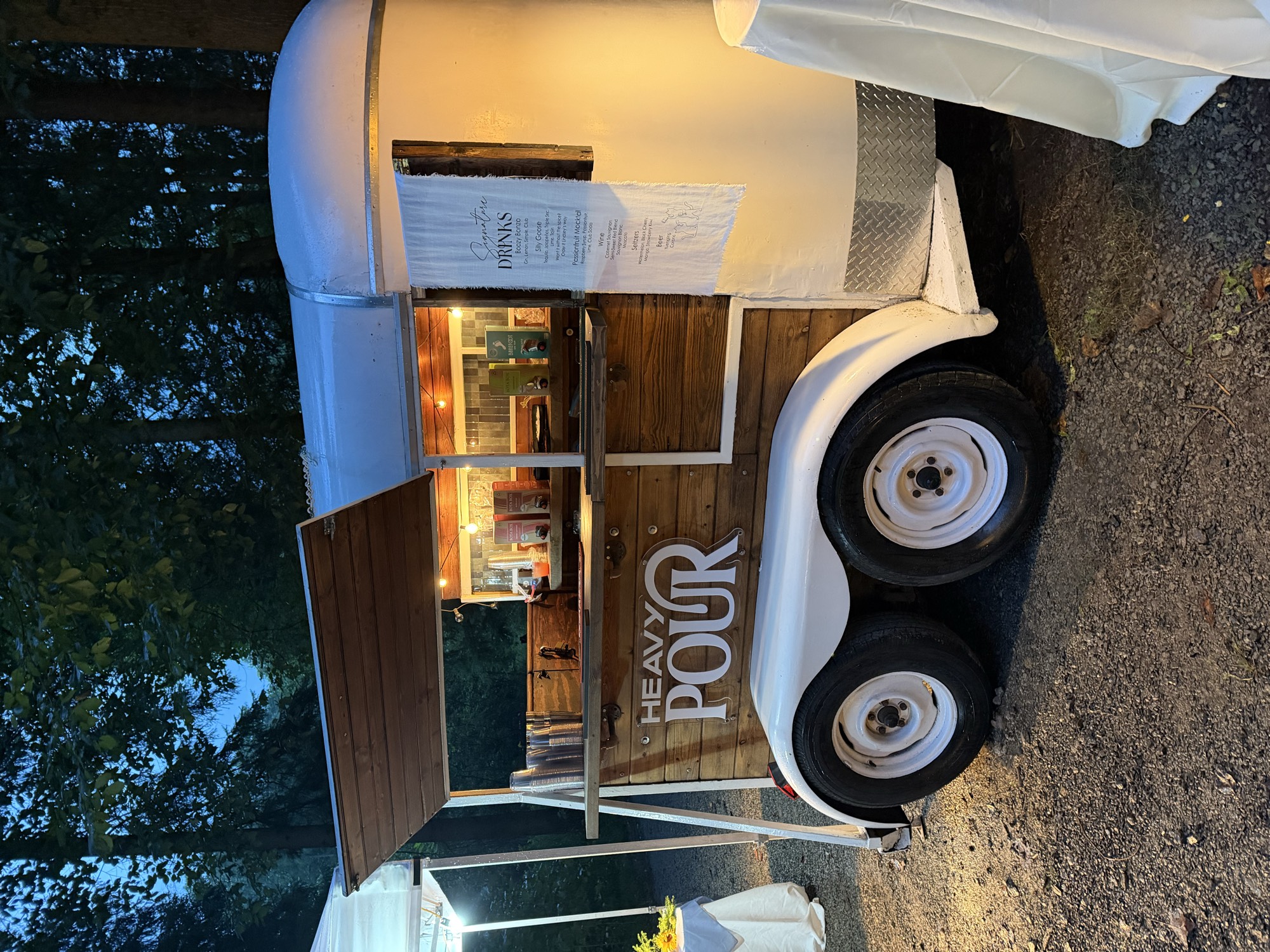Heavy Pour bar trailer branded and lit up at a recent event